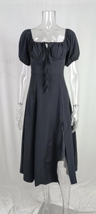 Detail of elegant black puff sleeve dress with square neck and side slit design
