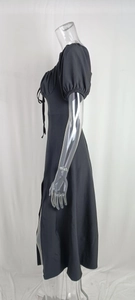 Detail of short puff sleeves and adjustable drawstring neckline on a black midi dress
