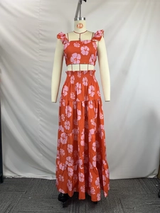 Detail showing tropical hibiscus print and ruffled layers on high-waist maxi skirt