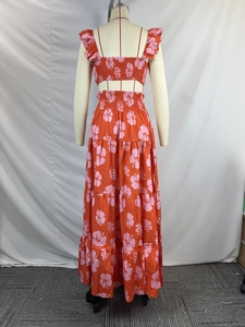 Detailed view of floral two-piece set with ruffle crop top and tiered maxi skirt