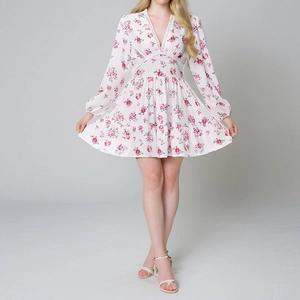 Detailed view of the V-neck with white lace trim on the pink floral print mini dress