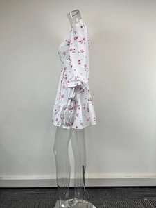 Detail of white floral V-neck dress with delicate lace trim and puffy long sleeves