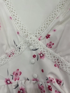Detailed V-neckline with delicate white lace trim and pink floral print on a summer dress