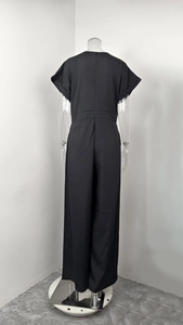 Back view of elegant black V-neck jumpsuit with short sleeves and wide legs