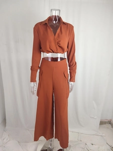 Detail of high-waist wide-leg pants with cargo pockets in burnt orange casual set