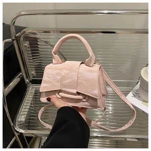 Detailed view of pink crossbody bag with marble texture and circular handle handle