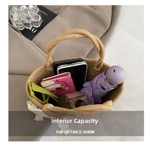 Detail showing the spacious interior of the woven straw tote bag with daily essentials