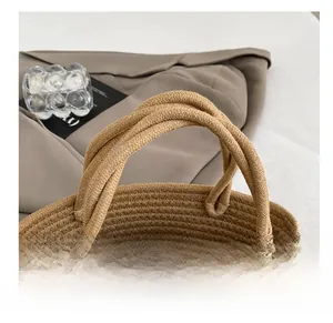 Close-up of woven tote bag with smooth handles and elegant white lace bow detail
