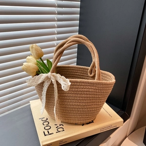 Artistic handmade straw woven handbag with white lace bow decoration and dual handles