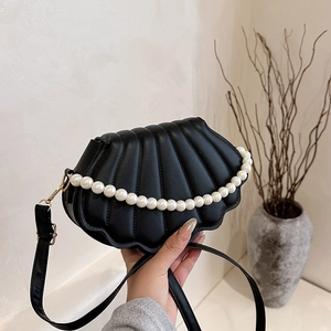 Chic black shell-shaped crossbody bag with pearl chain and quilted faux leather finish