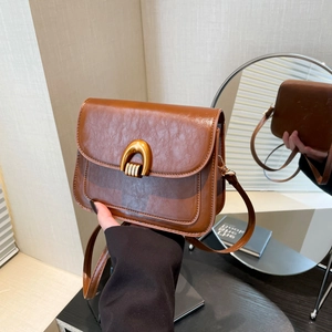 Retro brown crossbody bag with gold U-shaped lock and vintage wrinkled leather texture