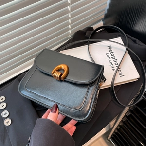 Retro black leather crossbody flap bag with a vintage bronze horseshoe metal buckle