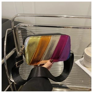 Close-up of colorful metallic crossbody camera bag with striped texture and gold hardware