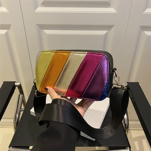 Rainbow striped crossbody camera bag with metallic finish and wide nylon shoulder strap