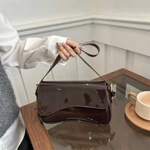 Glossy dark brown patent leather shoulder bag with gold hardware and flap closure