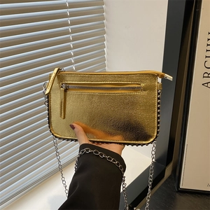 Chic gold metallic chain bag with vintage texture and silver rivet details on the front