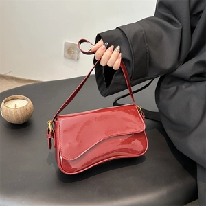 Red patent leather small square bag with asymmetrical flap and gold metal buckles