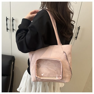 Detail of pink tote bag featuring transparent window for badges and suede texture surface
