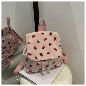 Detail of pink corduroy mini backpack with strawberry prints and drawstring closure