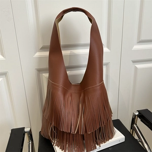 Brown litchi grain hobo bag with tiered leather tassels and a wide shoulder strap