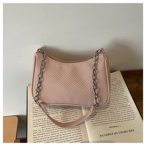 Detail of light pink shoulder bag with textured twill weave and silver metal chain