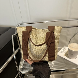 Vintage large straw woven tote bag with brown fabric handles for summer picnic and beach