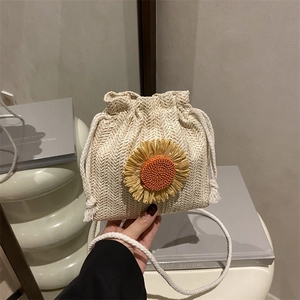 Handmade cream woven bucket bag with sunflower decor and drawstring strap for women