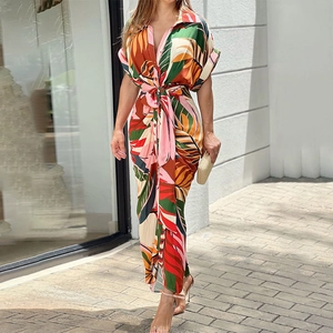Detail of tropical print shirt dress featuring a lapel collar and waist tie design