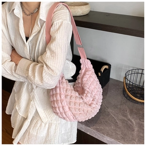 Close-up of pink popcorn textured shoulder bag showing soft pleated fabric detail