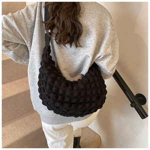 Detailed view of black bubble textured cloud tote bag on model for casual daily outfit
