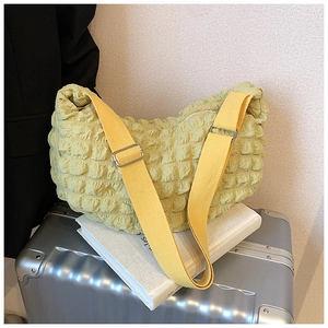 Detailed close-up of the light yellow puffer tote bag featuring unique bubble texture fabric