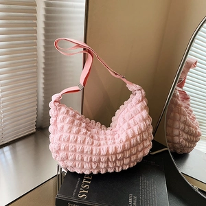 Pink pleated moon shoulder bag with soft bubble texture and adjustable strap in soft light