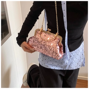 Detail of pink sequin evening bag with vintage gold clasp and delicate chain strap