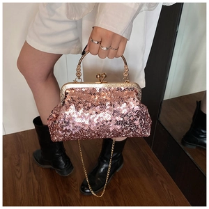 Detail of rose gold sequin evening bag with gold metal handle and beaded accents