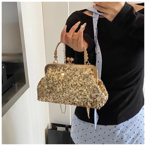 Detail view of the golden sequin evening bag featuring a metallic handle and pearl chain