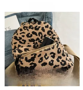 Close-up of leopard print corduroy backpack featuring detailed texture and zipper pocket