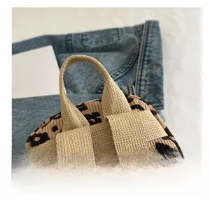 Close-up of leopard print corduroy backpack top handle with reinforced stitching detail