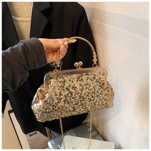 Detail view of vintage gold sequin evening bag with metallic handle and clasp