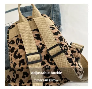 Close-up of leopard print corduroy backpack featuring adjustable straps and plastic buckle