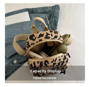 Interior capacity display of leopard print corduroy mini backpack with various items