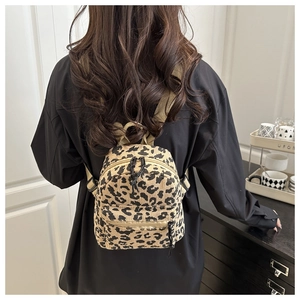 Close-up of leopard print corduroy mini backpack showing soft fabric texture and straps