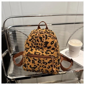 Detail of mini leopard print corduroy backpack with front pocket and woven straps