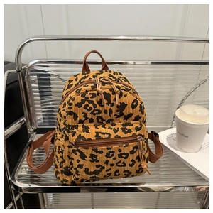 Macro shot of leopard print corduroy backpack texture and premium zipper detail