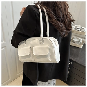 Detail showing white rectangular shoulder bag with dual front pockets and silver hardware