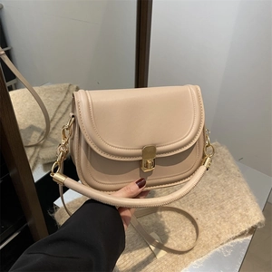 Chic beige solid color flap crossbody bag with gold metal buckle and top handle
