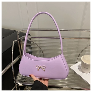 Detail of lavender PU leather underarm bag featuring a golden metal bow buckle