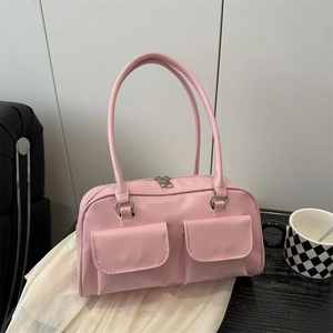 Pink faux leather underarm bag with double front pockets and thin handles for daily commuting