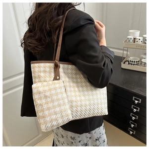 Detail showing woven houndstooth pattern and brown trim on a stylish lady's tote bag set