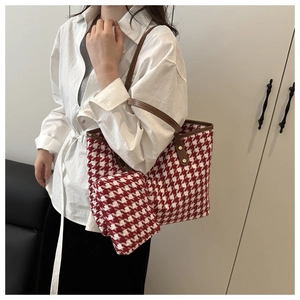 Detail of red houndstooth tote bag set with brown handles and matching pouch