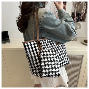 Classic houndstooth tote bag with brown leather straps and matching small pouch